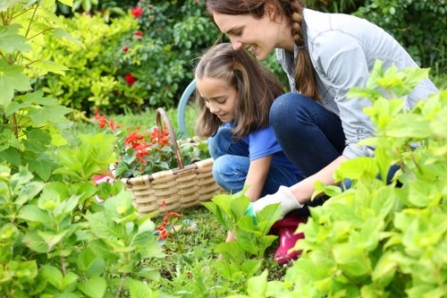 Gardener assessing a front garden in Heston before providing a quote